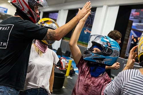 family high fives at a k1 speed during family fun day