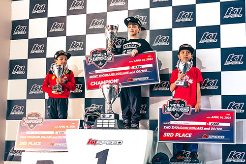 the top three from k1 speed's 2024 junior world championship stand on the podium