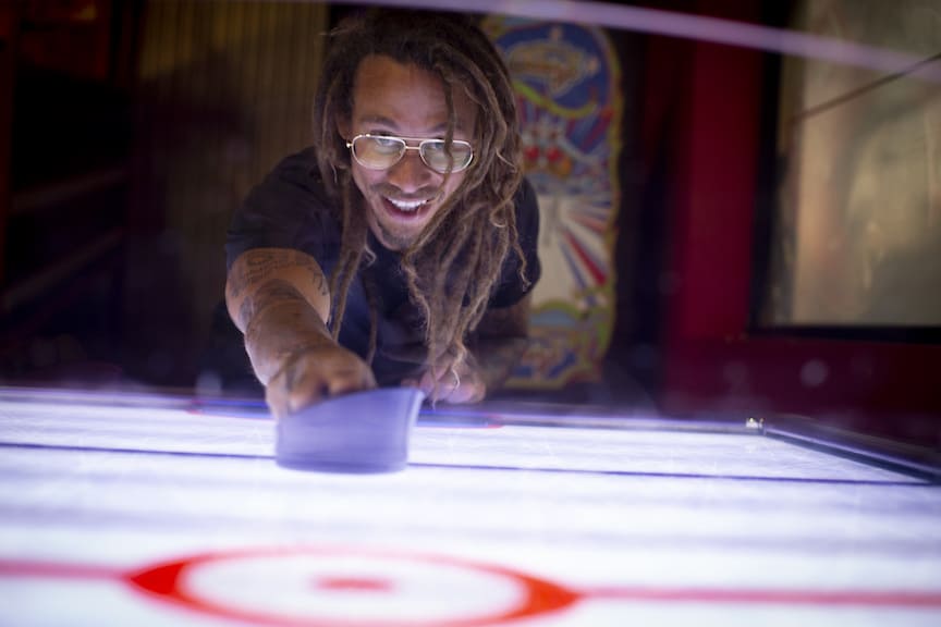 Man plays air hockey at K1 Speed Irvine