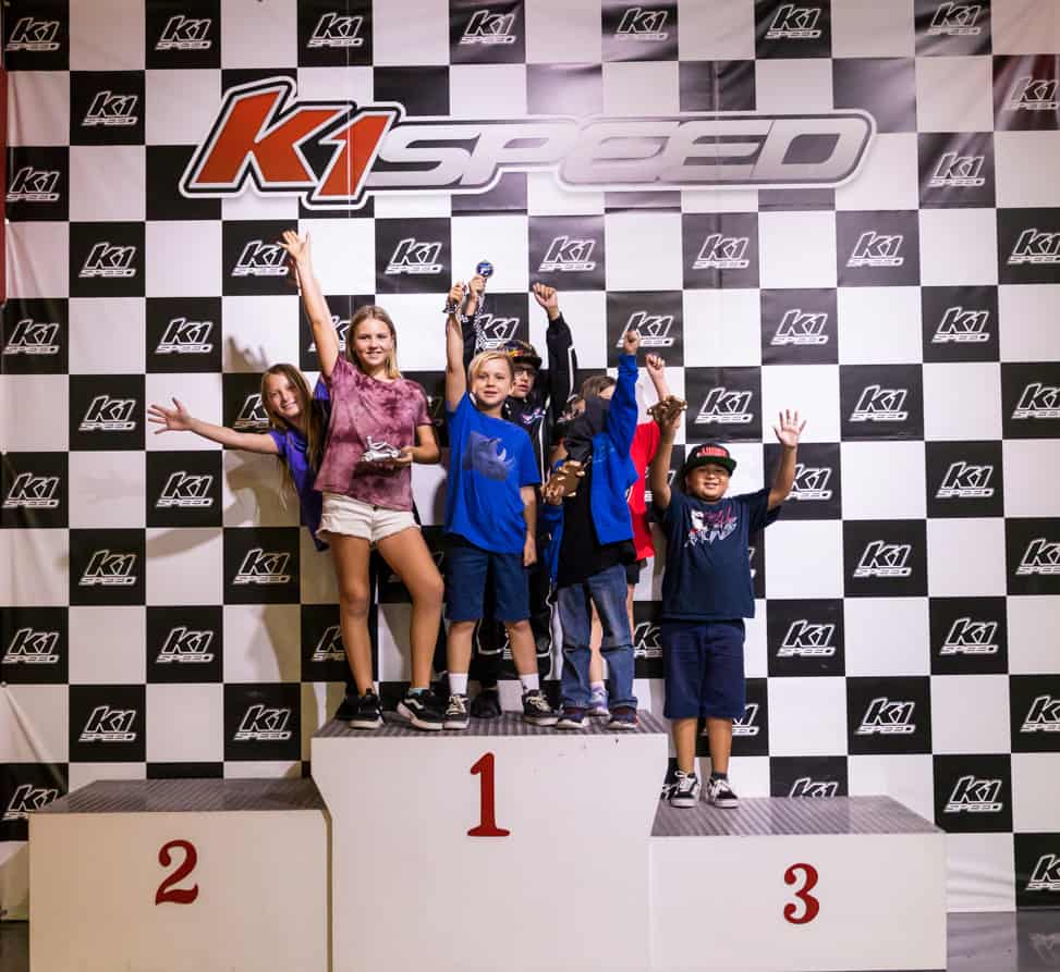 juniors celebrating on podium at k1 speed
