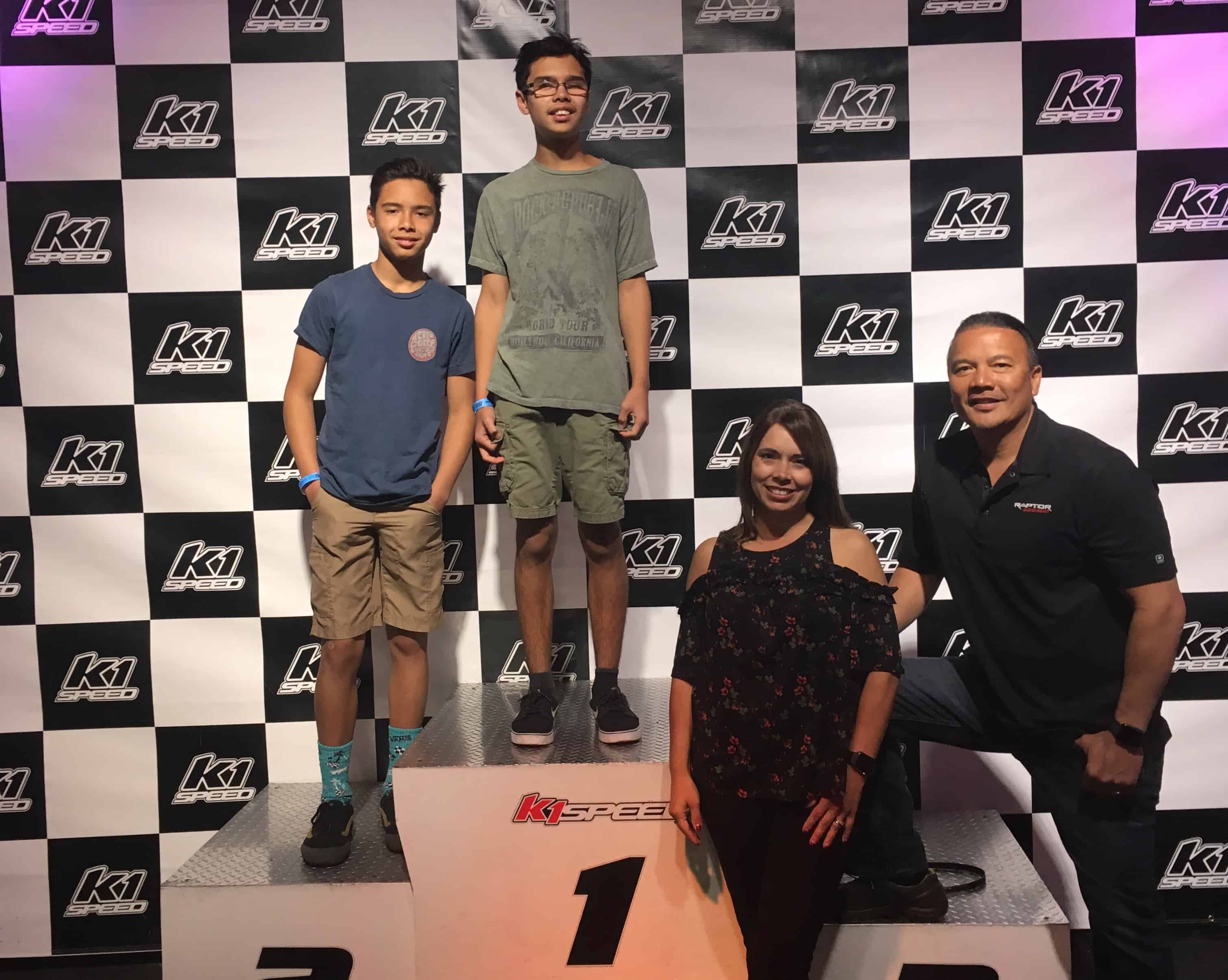 Christian with his brother, father, and mother on the podium at K1 Speed Irvine