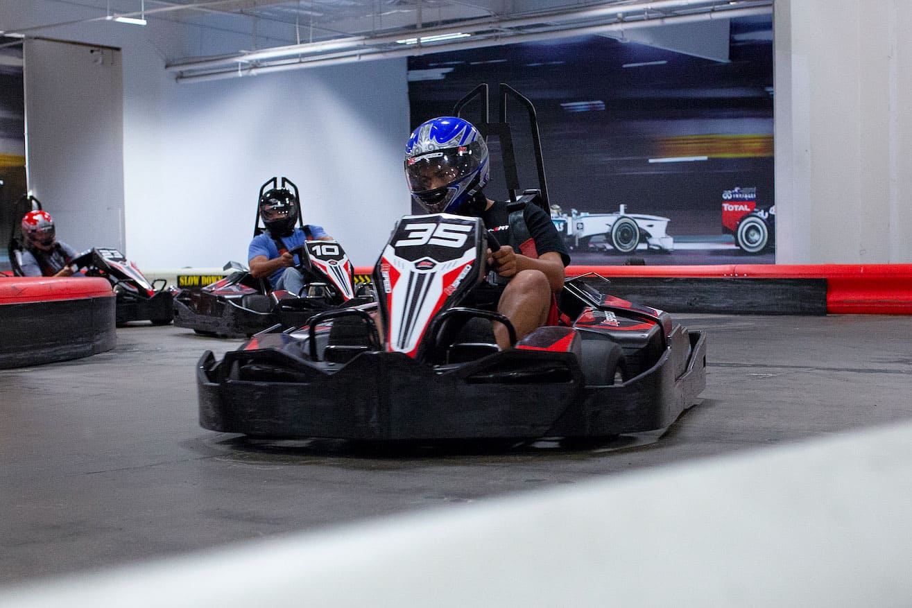 someone racing a go kart at k1 speed - a great indoor winter activity