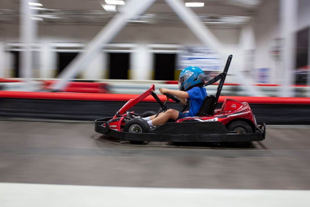 a kid drives a go kart at k1 speed