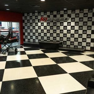 the lobby at k1 speed with a podium and display kart