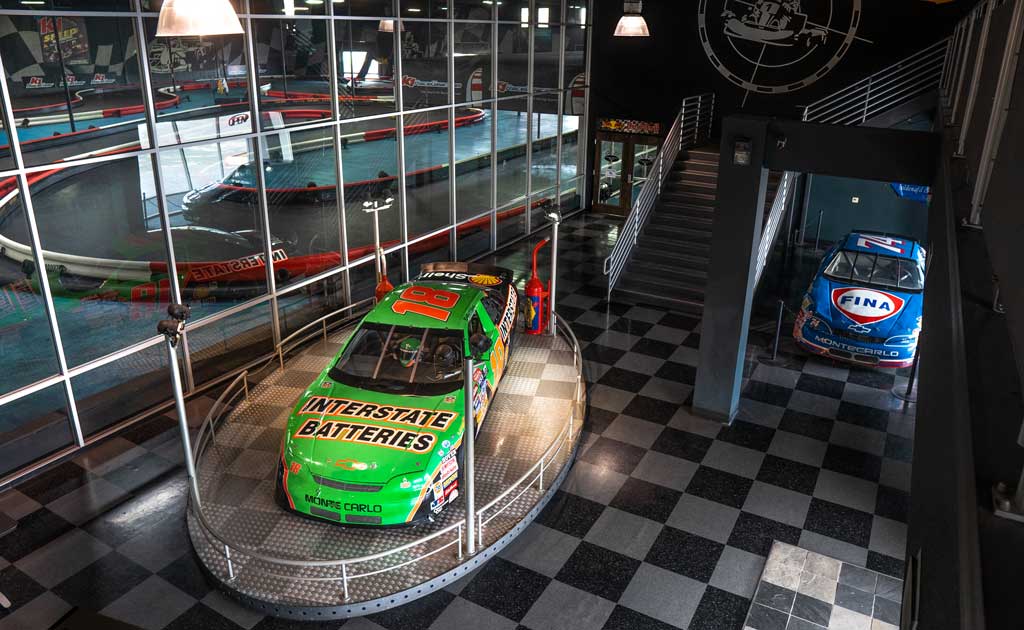 a NASCAR vehicle sits on display in the lobby of K1 Speed Sacramento