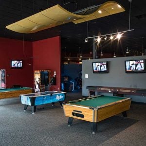 the gaming area inside k1 speed addison with pool tables and air hockey