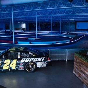 a nascar vehicle sits on display next to the track at k1 speed houston
