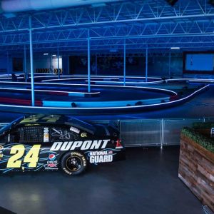 a nascar vehicle sits on display next to the track at k1 speed houston