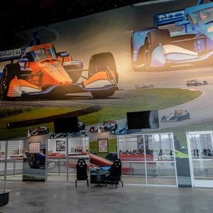 the lobby at k1 speed canton featuring a large wall with indycars at mid ohio
