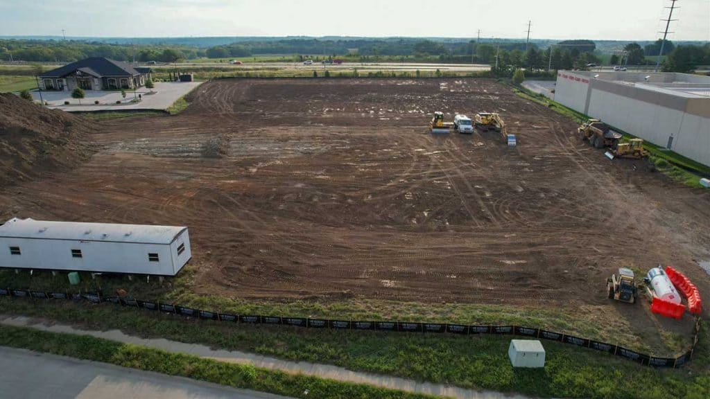 A bulldozer runs over a plot of land where K1 Speed Lee's Summit will stand