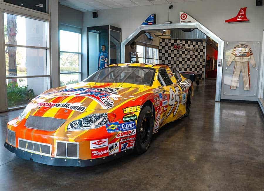 a nascar vehicle sits parked in the lobby of k1 speed corona
