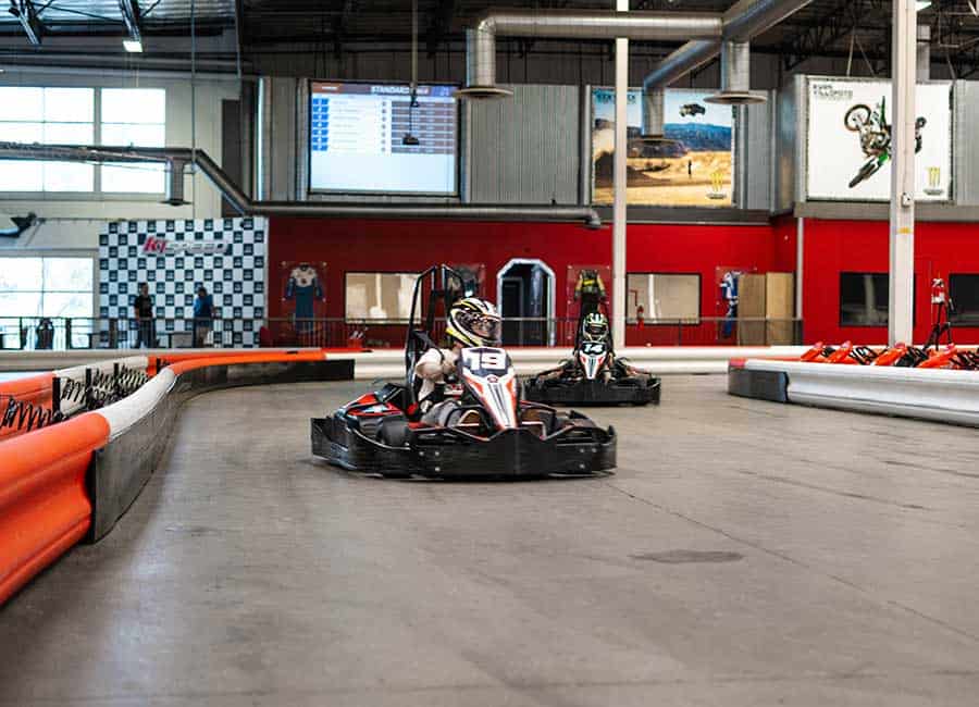 a go kart races on the track at k1 speed corona