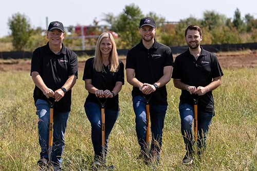 Franchise owners stand with shovels during the groundbreaking for K1 Speed Lee's Summit in MO