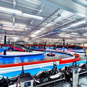 go karts race at the track at k1 speed daytona beach with go karts in the pits in the foreground