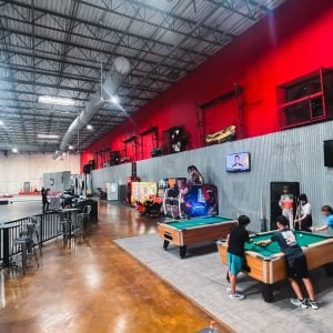 visitors play in the arcade at k1 speed tampa bay near the indoor track