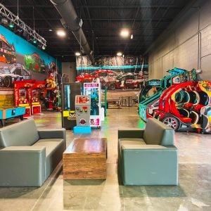 another shot of the lobby at k1 speed rogers with arcade games and leathers chairs