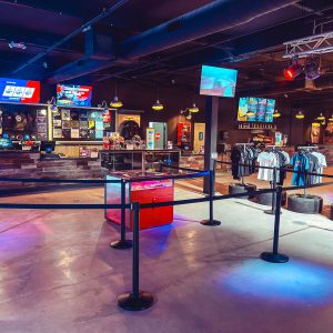 another shot of the lobby at k1 speed phoenix with tv screens and a retail space