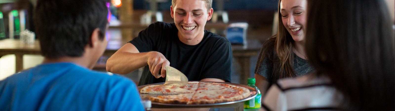 Friends enjoying pizza and soda