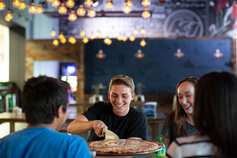 Friends enjoying pizza and soda