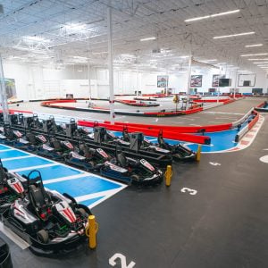 rows of go-karts sit in the pits next to the indoor go kart track at k1 speed chula vista