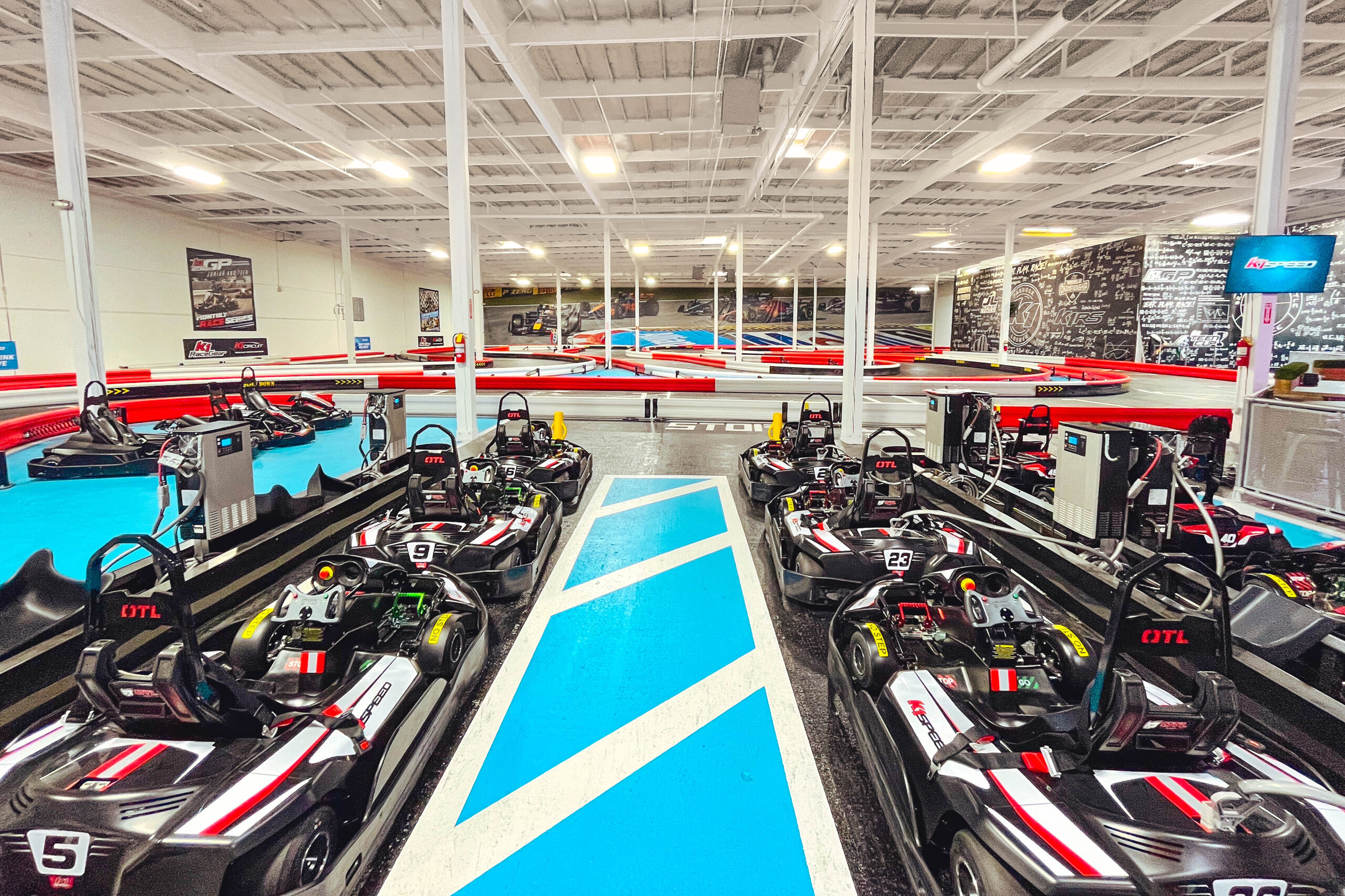 the interior of k1 speed tukwila with go-karts lined up and an indoor track