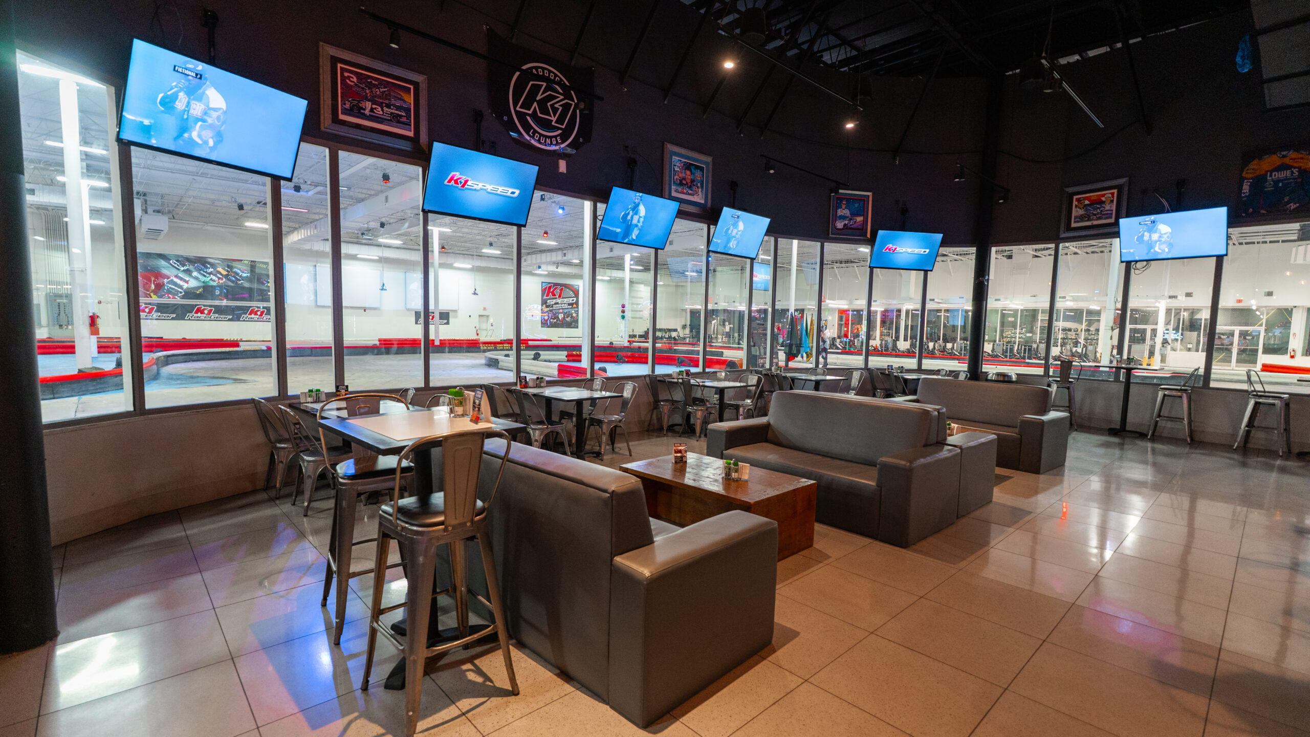 Dining area at K1 Speed Orlando's Paddock Lounge, with a view of the race track.