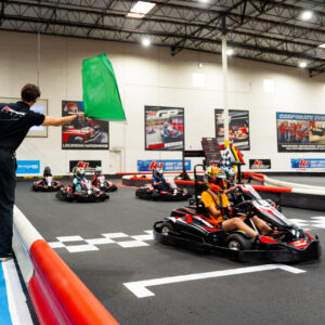 a k1 speed employee waves the green flag to start a race during the 2025 jr us and world championship