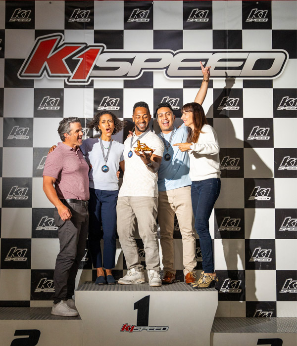 A company event ends with employees taking the podium at K1 Speed