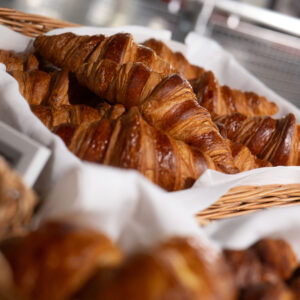 golden brown croissants lay in a basket at k1 speed