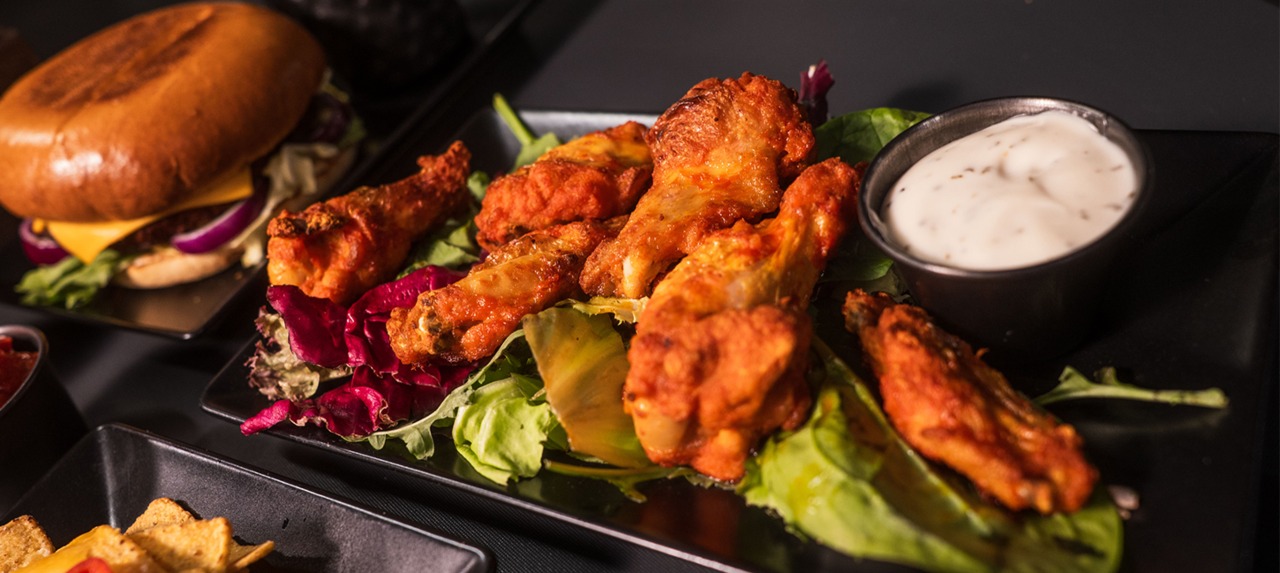 a close-up shot of chicken wings at k1 speed canary wharf