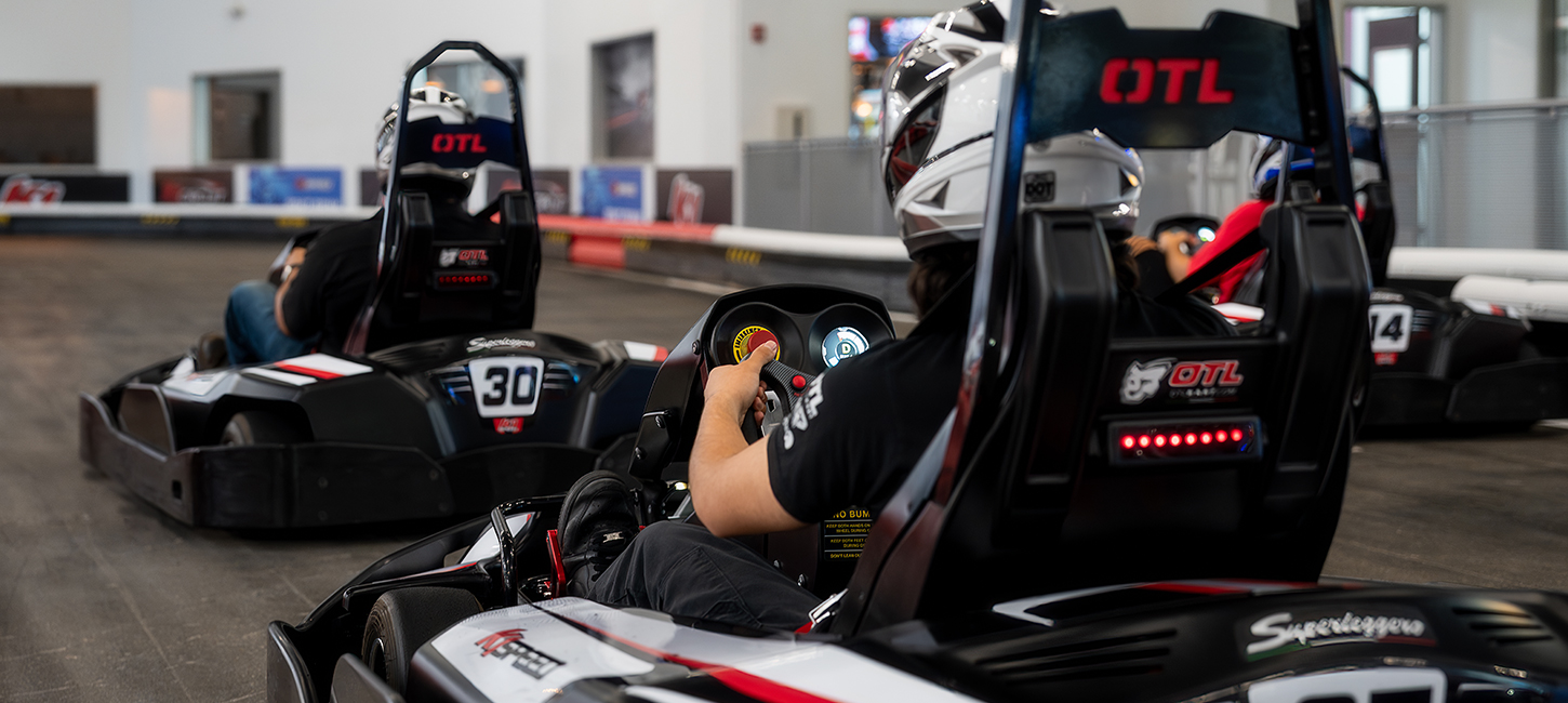 an over-the shoulder image of someone racing a go kart
