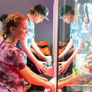 a girl plays a claw game in the arcade at k1 speed