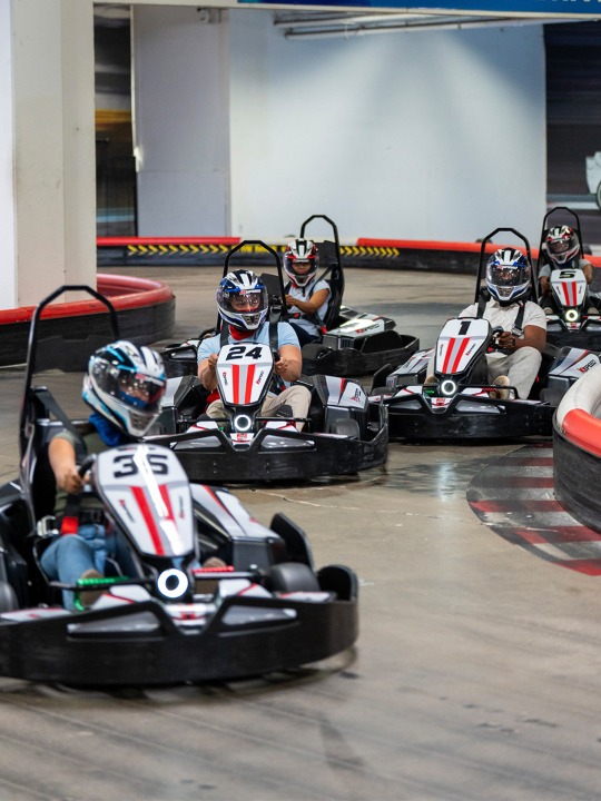 a string of go karts racing at k1 speed