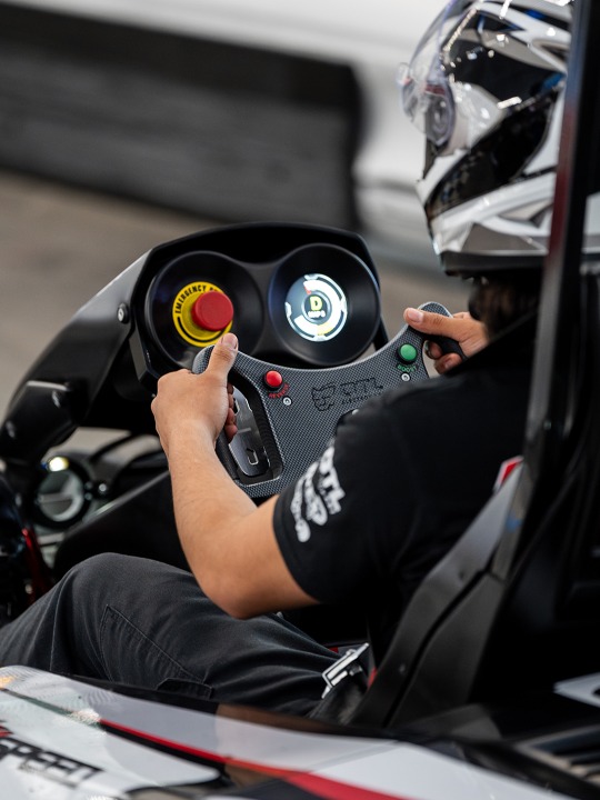 a close up shot of someone racing a go kart