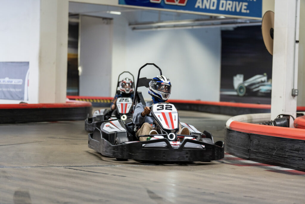 Teens racing electric go karts at K1 Speed