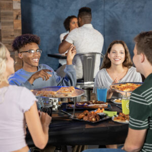 Teens enjoy food and beverages during a birthday party at K1 Speed.