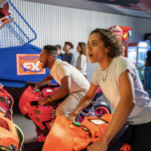 couple plays arcade games at k1 speed san diego