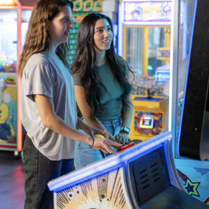 two girls play an arcade game at k1 speed san diego