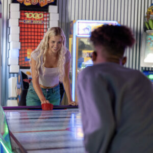 two kids play air hockey at k1 speed san diego