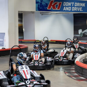 a group of people racing go-karts at k1 speed in san diego