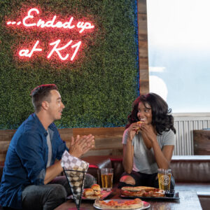 a couple sits and eats at k1 speed san diego