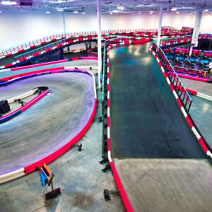 The elevated track at K1 Speed Boise, lit by pink LED lights