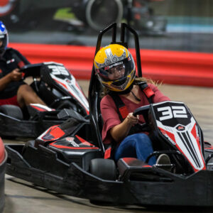 Two people racing go-karts at K1 Speed