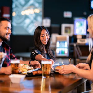 Adults eating and drinking at the paddock lounge