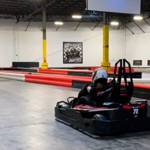 A karter races down a straight on the indoor go karting track at K1 Speed Jessup.