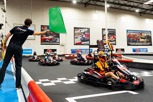 the green flag drops at the start of a go-kart race at k1 speed