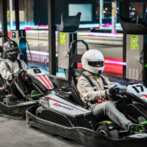teenagers sit in go-karts at k1 speed in oxford, mi