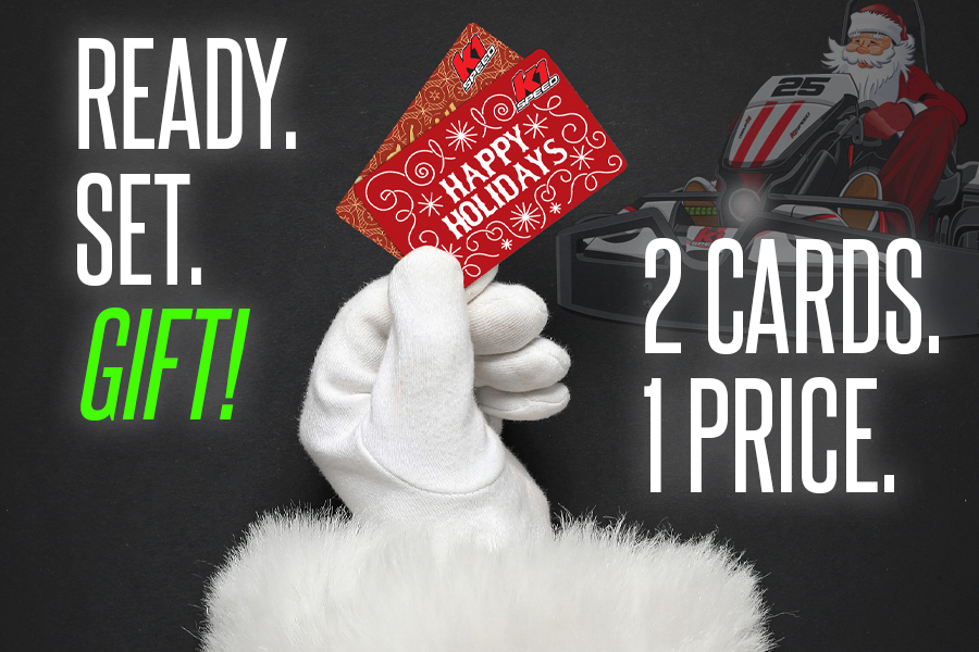 santa's gloved hand holding two gift cards with text reading "ready. set. gift" "2 cards. 1 price."