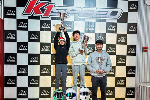 The Ramirez family holds their trophies on the podium at K1 Speed Anaheim.