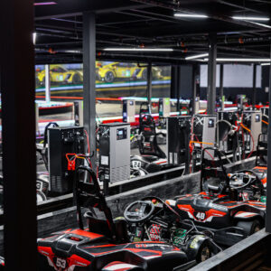rows of electric go-karts in the pits at K1 Speed in Oxford, Michigan